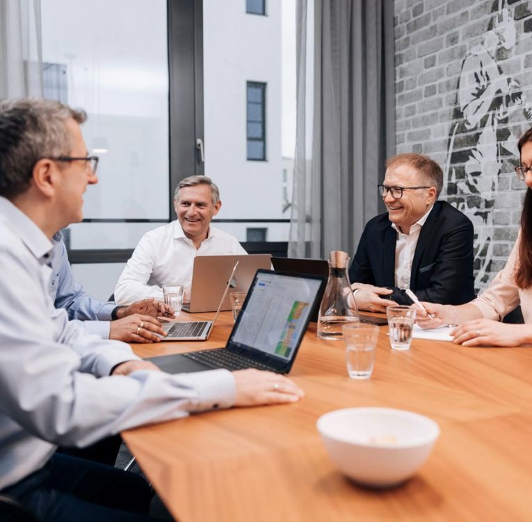Ledelsesteamet hos Software4You i strategimøde med fokus på HR-controlling og workforce-analyse med integreret Timegrip-data på skærmen.